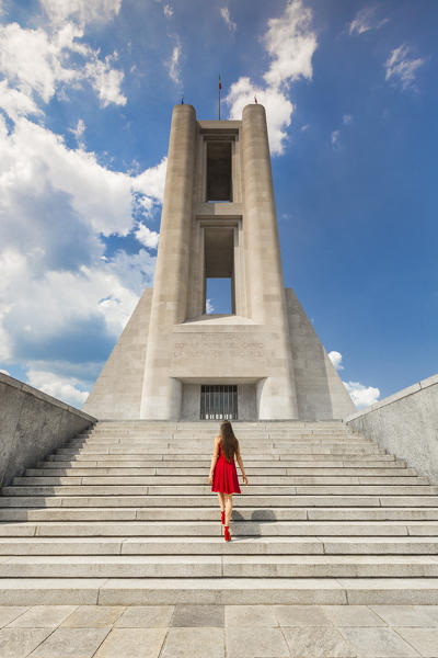 A tourist go up the stairs of War Memorial monument (Monumento ai Caduti), Como city, Lombardy, Italy, Europe (MR)