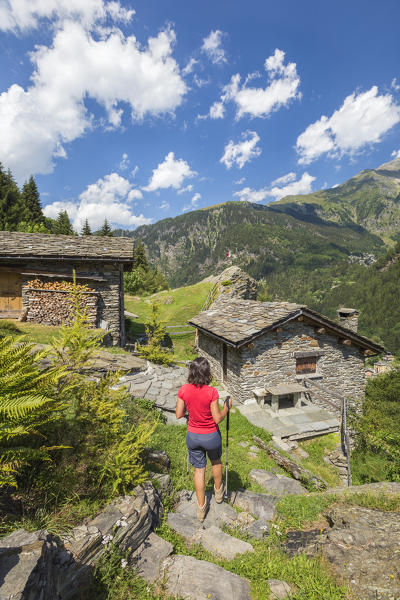 Hiker walks on the path, Alpe Zanon, Campodolcino, Sondrio province, Spluga valley, Lombardy, Italy, Europe (MR)