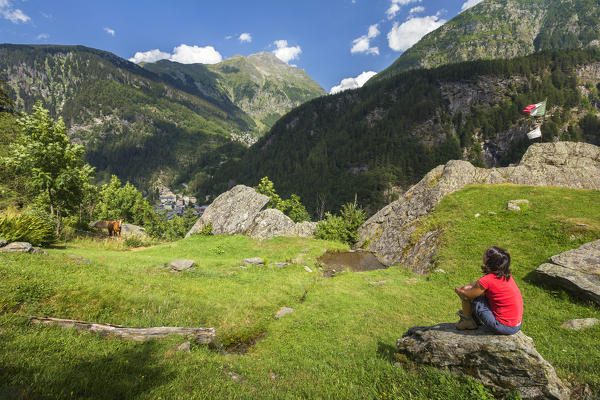 Hiker take relax on the rock and looks the Groppera piz from Alpe Zanon, Campodolcino, Sondrio province, Spluga valley, Lombardy, Italy, Europe (MR)