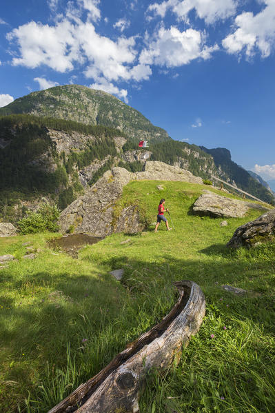 Hiker walks on the path, Alpe Zanon, Campodolcino, Sondrio province, Spluga valley, Lombardy, Italy, Europe (MR)