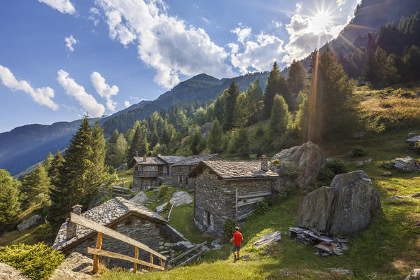 Hiker arrive to the Alpe Zanon, Campodolcino, Sondrio province, Spluga valley, Lombardy, Italy, Europe (MR)