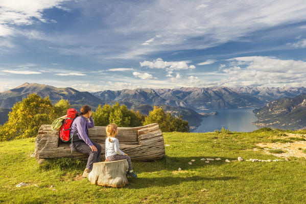 Mom and son relaxing and looks lake Como (ramo di Lecco) from Sev refuge, Valbrona, Corni di Canzo, Como and Lecco province, Lombardy, Italy, Europe (MR)