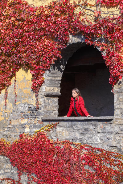 A tourist looks lake Como from Nesso village in the Autumn, Como province, Lombardy, Italy, Europe (MR)