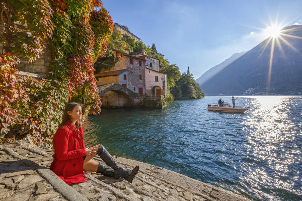 A tourist looks lake Como from Nesso village in the Autumn, Como province, Lombardy, Italy, Europe (MR)