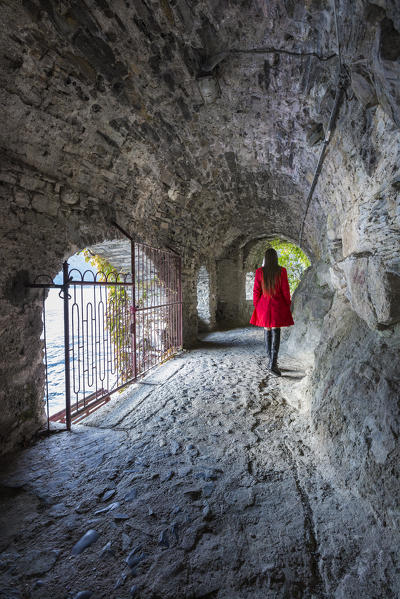 A tourist walks and visit Nesso village in the Autumn, lake Como, Como province, Lombardy, Italy, Europe (MR)