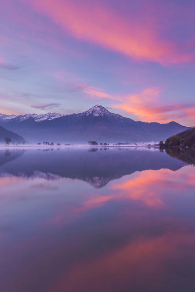 Sunrise on Legnone mount (Lecco province) reflected into Mera river from Dascio village, Sorico, Riserva Naturale Pian di Spagna e Lago di Mezzola, lake Como, Como province, Lombardy, Italy, Europe