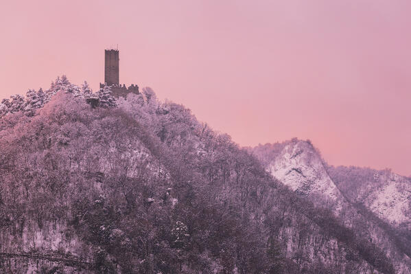 Sunset on Baradello tower (Castel Baradello) after the snowfall, Como city, lake Como, Lombardy, Italy, Europe