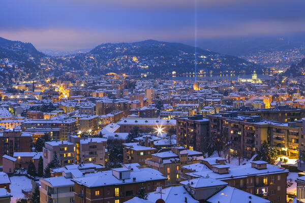 A night view on Como city after the snowfall with Christmas Light Tree event, lake Como, Lombardy, Italy, Europe