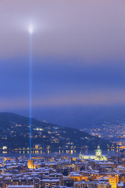 A night view on Como city after the snowfall with Christmas Light Tree event, Como's cathedral, lake Como, Lombardy, Italy, Europe