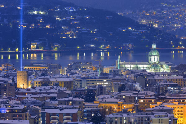 A night view on Como city after the snowfall with Christmas Light Tree event, Como's cathedral, Porta Torre, lake Como, Lombardy, Italy, Europe