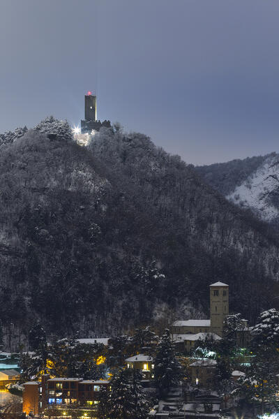 A night view on Baradello tower (Castel Baradello) after the snowfall, Como city, lake Como, Lombardy, Italy, Europe