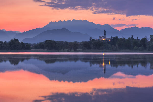 Sunrise on Resegone and Barro mount reflected on Pusiano lake, Garbagnate Rota church, Lecco  province, Lombardy, Italy, Europe