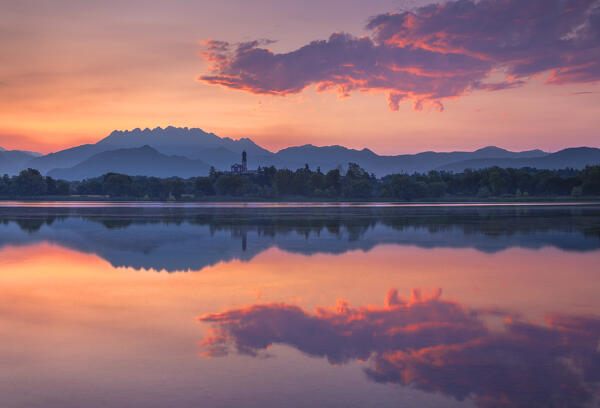 Sunrise on Resegone mount reflected on Pusiano lake, Lecco province, Lombardy, Italy, Europe