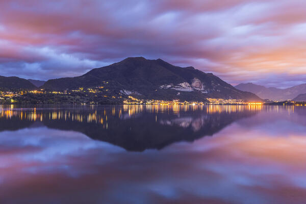 Dawn on Cornizzolo mount reflected on Pusiano lake, Lecco province, Lombardy, Italy, Europe