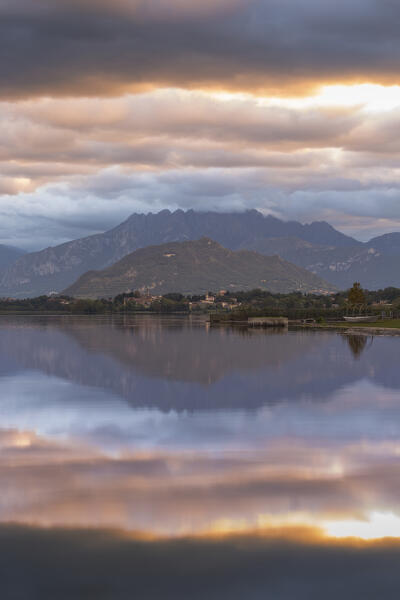 Sunrise on Resegone and Barro mount reflected on Pusiano lake, Lecco province, Lombardy, Italy, Europe