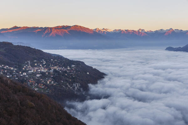 A view of lake Como (ramo di Lecco) covered by the fog at sunrise, from Civenna village to Valtellina mountains, Como and Lecco province, Lombardy, Italy, Europe
