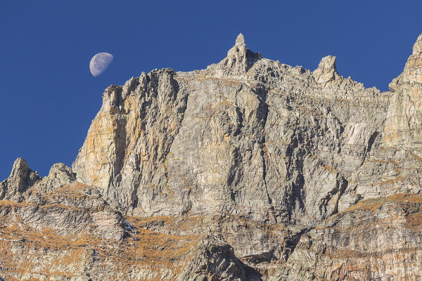 Sunset of the moon behind mountains of Alpe Devero, Nero lake (lago Nero), Baceno, Alpe Veglia and Alpe Devero natural park, province of Verbano-Cusio-Ossola, Piedmont, italy, Europe