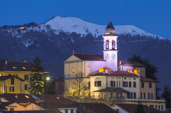 Dusk on the church of SS Cosma e Damiano, Boletto mount snowy in the background, Civello village, Villa Guardia, Brianza, Como province, Lombardy, Italy, Europe