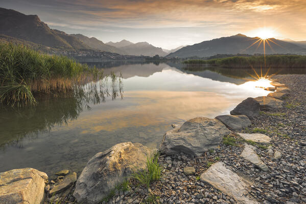 First rays of the sun on lake Annone, Brianza, Lecco province, Lombardy, Italy, Europe