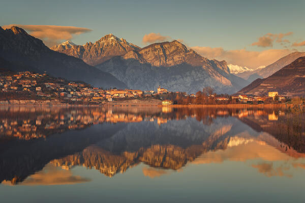 Sunset on lake Annone with Civate village and Lecco mountains reflected, Brianza, Lecco province, Lombardy, Italy, Europe