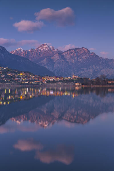 Dusk on lake Annone with Civate village and Lecco mountains reflected, Brianza, Lecco province, Lombardy, Italy, Europe