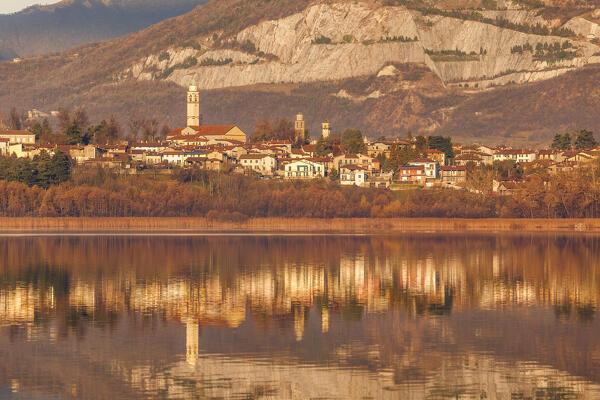 Annone di brianza village reflected on lake Annone, Brianza, Lecco province, Lombardy, Italy, Europe