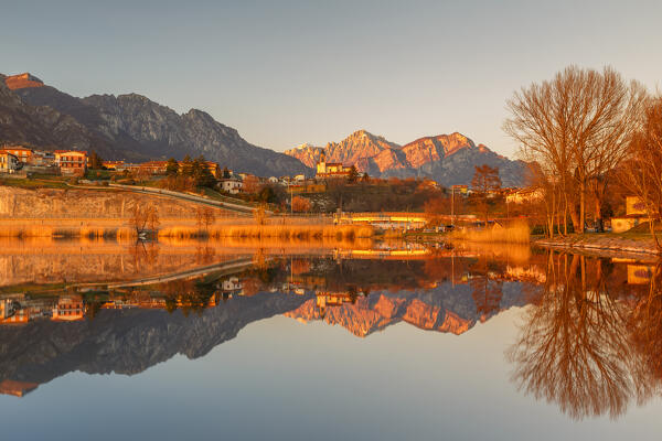 Sunset on lake Annone with Civate village and Lecco mountains reflected, Brianza, Lecco province, Lombardy, Italy, Europe