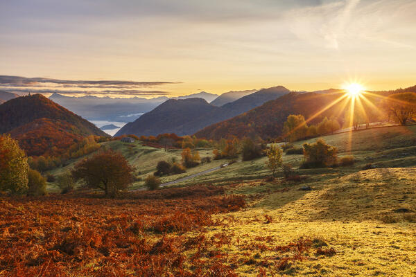 First autumn light on Piano delle Alpi. Cerano d'Intelvi, Intelvi valley (val d'Intelvi), lake Como, Como province, Lombardy, Italy, Europe