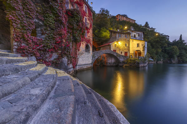 Nesso village illuminate at Dusk in autumn time, lake Como, Como province, Lombardy, Italy, Europe