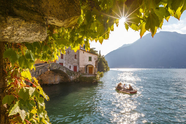 Ivy plants frame the Nesso village, lake Como, Como province, Lombardy, Italy, Europe