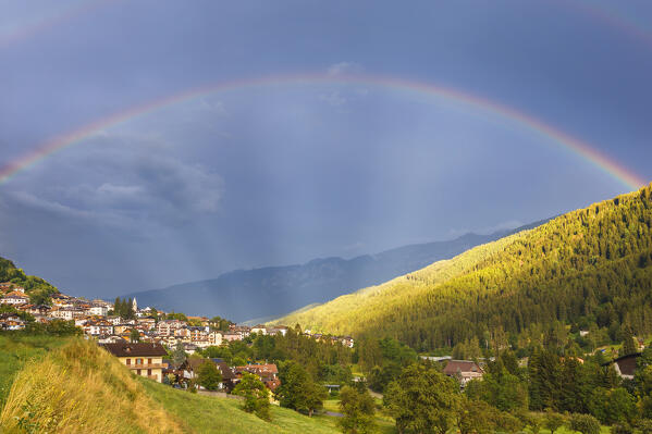 Rainbow over Mezzana village and Sun valley (val di Sole), Trento province, Trentino alto adige, Italy, Europe
