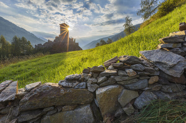 First lights on St. Michael castle (Castello di San Michele), Ossana village, Sun valley (val di Sole), Trento province, Trentino alto adige, Italy, Europe