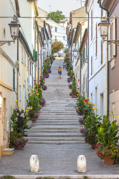 A tourist walks on the La Costarella staircase, Numana village, Riviera del Conero, Ancona province, Marche, Italy, Europe