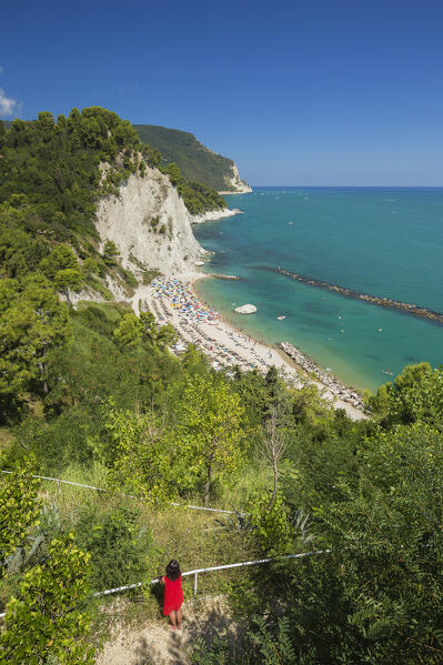 A tourist looks panorama of the Spiaggia del Frate beach, Adriatic sea, Numana, Riviera del Conero, Ancona province, Marche, Italy, Europe (MR)