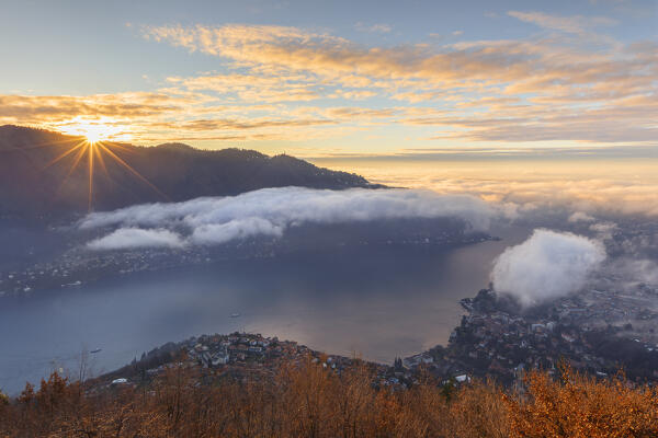 First ray of sunshine on lake Como, Brunate and Cernobbio town, Como province, Lombardy, Italy, Europe