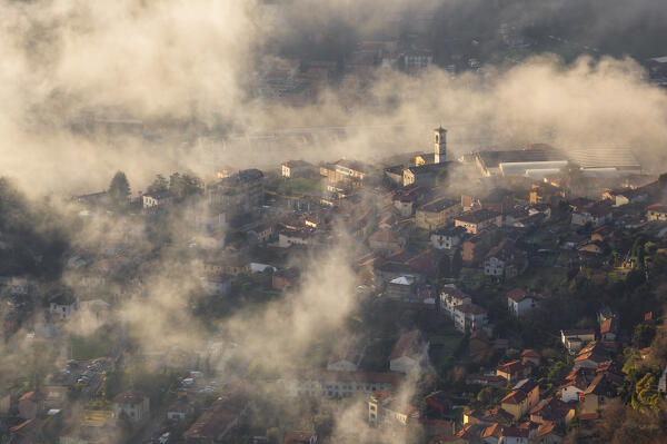 Cernobbio town wrapped by the morning fog, lake Como, Como province, Lombardy, Italy, Europe