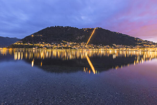 Dawn on Brunate and Como city reflected in the lake Como, Lombardy, Italy, Europe