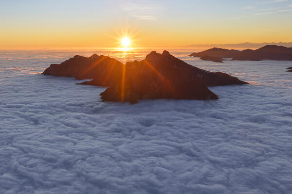 Sunset above the clouds on Moregallo mount, Corni di Canzo and Rai mount. 
View from the top of Coltignone mount, Pian dei Resinelli, lake Como, Como and Lecco province, Lombardy, Italy, Europe