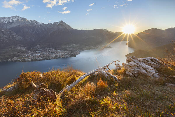 First ray of sunshine on lake Como (ramo Lecco) with Grigna mounts. Barni, Como and Lecco province, Lombardy, Italy, Europe
