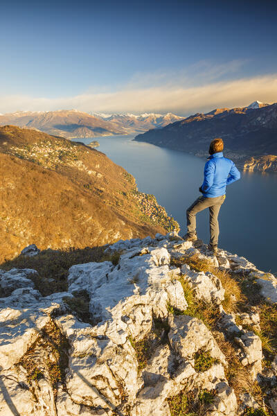Hiker looks the beauty of lake Como (ramo di Lecco), Barni, Como province, Lombardy, Italy, Europe (MR)