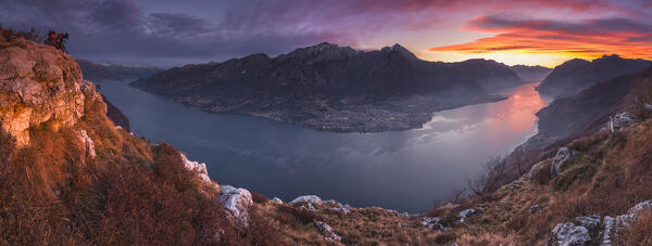 Photographer capture a picture on lake Como (ramo di Lecco) during a red sunrise. Grigna group, Barni, Lecco and Como province, Lombardy, Italy, Europe (MR)