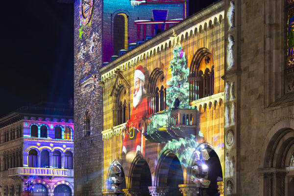 Broletto tower illuminated and animated at night during the Christmas time, Città dei Balocchi, Como city, Lombardy, Italy, Europe