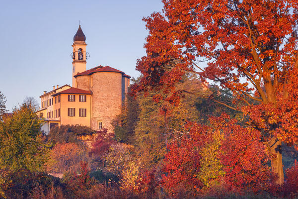 Autumnal trees frame the Villa Guardia church illuminated by the first ray of the morning. Brianza, Como province, Lombardy, Italy, Europe