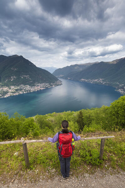 Hiker looks lake Como (Ramo di Como) from Montepiatto, Torno, lake Como, Como province, Lombardy, Italy, Europe (MR)