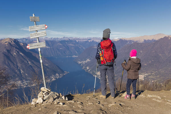 Mom and daughter looks lake Como (ramo di Como) from the top of Boletto mount, Larian Triangle, Como province, Lombardy, Italy, Europe (MR)