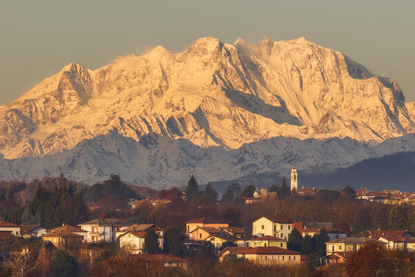 Morning lights illuminate Rosa mount massif (Italy and Switzerland) and Gaggino village. A view from Colverde, Como province, Lombardy, Italy, Europe