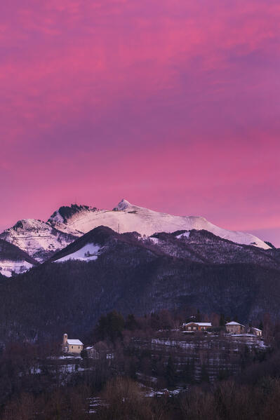 Sunrise on Generoso mount and Alpe di Caviano (canton of ticino,Switzerland), Drezzo church (Como province, Lombardy, Italy). A view from Colverde, Gironico Como province, Lombardy, Italy, Europe
