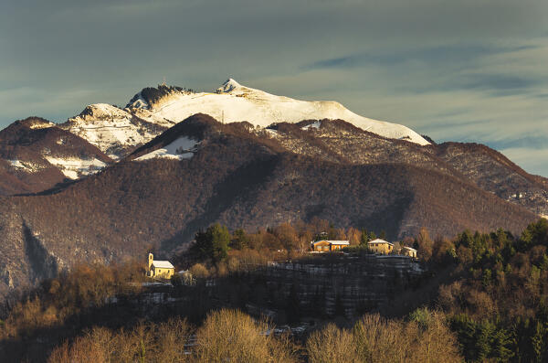 Generoso mount and Alpe di Caviano (canton of ticino,Switzerland), Drezzo church (Como province, Lombardy, Italy). A view from Colverde, Gironico Como province, Lombardy, Italy, Europe