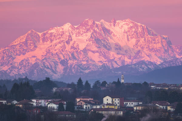 Sunrise on Rosa mount massif (Italy-Switzerland), and Gaggino village. A view from Colverde, Como province, Lombardy, Italy, Europe