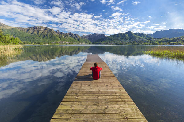 Man relaxes looking at Annone lake, Brianza, Lecco province, Lombardy, Italy, Europe (MR)